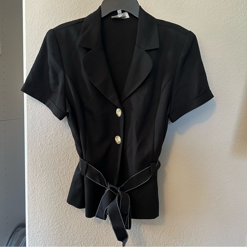 Black two-button top with belt. 100% polyester.
